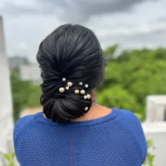 A slightly different angle of the classic low bun, showing the placement of the decorative pins.