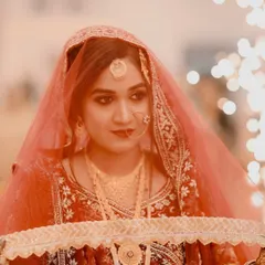 A dramatic close-up of my bride during her entrance. The makeup is designed to be captivating, with smoky eyes and a perfect base that glows under the lights.