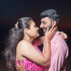 A candid moment of love and affection between the couple on the beach. Our pre-wedding photography aims to capture the natural chemistry and connection you share.