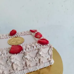 This is my vintage-style anniversary cake, decorated with intricate piping and fresh strawberries. It's a beautiful and elegant way to celebrate a special milestone.