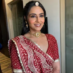 A close-up of the happy bride. The shimmery eyes and glossy lips create a beautiful glow that ties in perfectly with her traditional outfit.