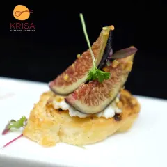 A sophisticated crostini topped with fresh fig, creamy ricotta, and a sprinkle of pistachio. This appetizer balances sweet and savory notes, showcasing our creative approach to gourmet catering for wine and cheese events.