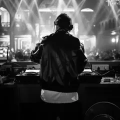 A black and white shot from behind the console at Hashtag in Kolkata. It captures the classic DJ moment, focused on the music and the crowd.