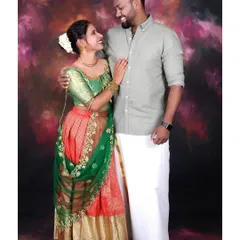 A studio couple portrait featuring traditional South Indian attire. I use professional lighting to bring out the rich colors and details of the outfits against a classic painted background.