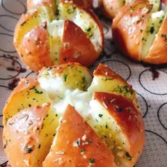 Freshly baked Korean Cream Cheese Buns, straight out of the oven. The buns are golden brown and filled with melted cream cheese.