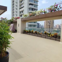 This wide view shows the scale of a terrace landscaping project. We used a combination of bamboo for privacy and rows of croton plants for color, creating a clean and modern look.