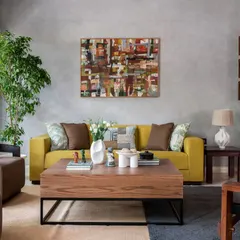 A closer view of the living area, highlighting the interplay of textures. The abstract artwork provides a pop of color against the serene grey wall, while the large wooden coffee table grounds the space, making it feel like home.