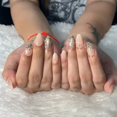 Another beautiful example of our bridal nail services. This client opted for elegant almond-shaped extensions with a subtle nude base, accented with glitter and a touch of animal print for a modern and chic look.