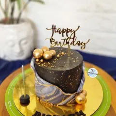 I love the effect of fondant marbling. This black and grey marbled cake with gold spheres and a "Happy Birthday" topper is a great example of a modern and masculine design.