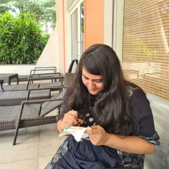 A student smiling as she works on her piece. My workshops are designed to be a happy escape where you can focus on creativity and enjoy the process.