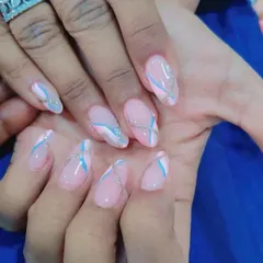 An abstract design on a pink base, featuring swirls of white and blue with a line of silver glitter for definition.