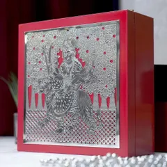 A powerful and elegant gift, this red keepsake box features a silver-plated depiction of Goddess Durga on her lion. The intricate detailing makes it a truly special and protective gift.