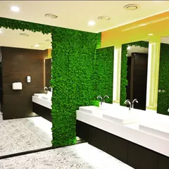 An alternate view of the moss wall installation in the Akamai Technologies restroom. The design covers the entire wall, maximizing the biophilic impact and creating an immersive green experience in an unexpected area.