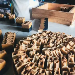 From my studio to your shelves. Here, I'm sorting through a large batch of freshly cut soaps, ensuring each one is perfect. My wholesale service is designed to be a simple, reliable way for you to enter the plant-based wellness market.