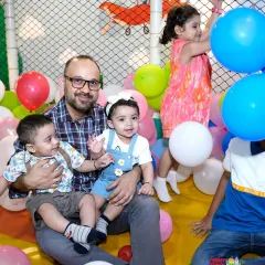 Look at these happy faces. A dad enjoys quality time with his little ones in our colorful ball pit, surrounded by balloons. It's all about creating these joyful family moments in a safe and fun environment.