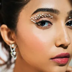 A closer view of the crystal eye makeup, showing the detail and artistry involved. Learning to work with embellishments is a key skill for a versatile artist.