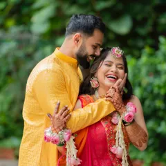 A moment of pure, uninhibited laughter during a Haldi shoot, showing the groom playfully applying haldi to the bride.