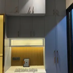 A closer look at the wardrobe and study table combination. The rose gold handles add a touch of elegance to the matte grey cabinets.