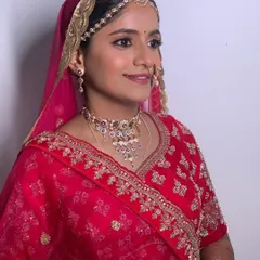 A side profile showing the traditional Rajasthani draping and jewelry, including the borla maang tikka and nath.