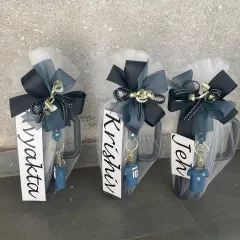 Personalized mugs wrapped and ready to be gifted as return favors. Each mug is customized with a name and a themed keychain, making it a fun and practical gift for kids' birthday parties.