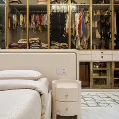 This angle shows the seamless connection between the bedroom and the open walk-in closet. The custom bedside table and the elegant wardrobe design create a cohesive and luxurious master suite.
