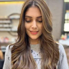 A close-up of a finished balayage, showing the soft, face-framing layers and expertly blended highlights. This look is perfect for anyone wanting a low-maintenance but high-impact style.