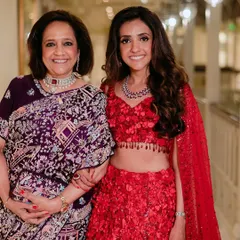 Coordinating looks for a mother and daughter. For the mother, I chose a sophisticated palette with a soft smokey eye that paired beautifully with her deep purple sari, while her daughter wore a vibrant red lehenga.