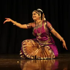 An inviting gesture during a performance. This open and welcoming posture is part of a piece that invites the audience into the story, sharing the joy and beauty of the dance.