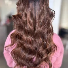 A perfect example of my signature balayage work. I hand-painted these highlights to create a seamless blend of rich brunette and caramel tones, finished with soft, voluminous waves.