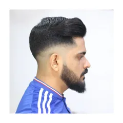 A clean high fade pompadour paired with a sharp beard shape. I focus on creating balanced, classic styles that are tailored to your look, ensuring the lines are perfect and the fade is seamless.