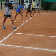 A group of advanced players in the ready position, preparing for a high-intensity fitness drill. Discipline and focus are emphasized in every training session.