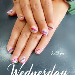 Another look at the fun and colorful striped nail art, showing the precision of the thin lines.
