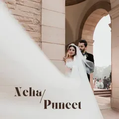 A dramatic portrait of a Christian bride and groom, with the bride's long veil flowing across the frame. This shot, taken outside a beautiful church in Delhi, has a timeless, classic feel.
