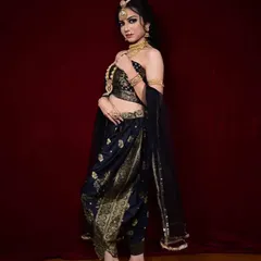 For a bold and unconventional look, I offer this black and gold dhoti-style saree. It's a modern take on traditional wear, perfect for someone who wants to make a unique style statement.