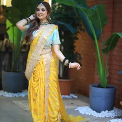 A full view of a bride in a stunning yellow Nauvari saree. I created a half up, half down hairstyle with soft waves, perfect for a modern yet traditional look.
