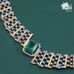 A detailed view of the Emerald Zarnaya necklace. The geometric precision of the diamond work contrasts beautifully with the rich, natural color of the central emerald.