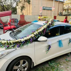 For a unique and royal look, I use premium flowers like these blue orchids. This design on a white Hyundai Elantra features a beautiful arrangement of white flowers and blue orchids.