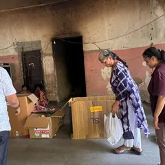 Community members work together to organize and pack dry waste into boxes during a residential collection drive. This collaborative spirit is at the heart of what we do.