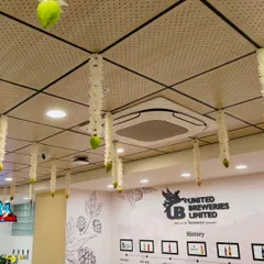 A view of the ceiling decor from the United Breweries office opening. We used delicate hanging floral strings made of white flowers to add a touch of tradition and elegance to the modern office space.