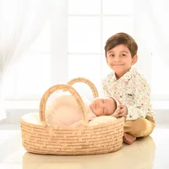A proud big brother smiles for the camera next to his sleeping newborn sibling. Sibling photos are a special part of my sessions, capturing the beginning of a lifelong bond in a gentle and safe environment.