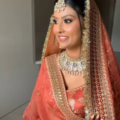 A side profile showing the warm, sculpted makeup on her beautiful brown skin. The goal was to enhance her glow, not mask it.
