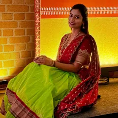 A lovely seated pose showing the comfort and grace of the langa voni. The rich colours and traditional border of the skirt stand out, making it a very photogenic outfit.