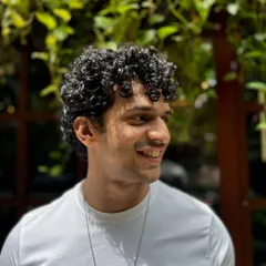 Curls for the win. This client's short, tight curls are perfectly defined and shaped for a stylish, effortless look that's easy to maintain.