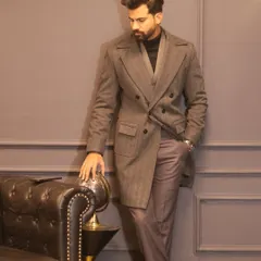 The craftsmanship of our long coat is evident in its structured shoulders and perfectly tailored lines.