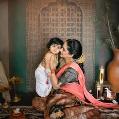 A tender moment between mother and child. The intricate details of the backdrop and props add to the authenticity of this cultural photoshoot.