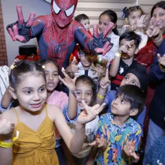 Imagine the look on your child's face when their favorite hero joins the party. We can arrange for special character appearances, like Spider-Man here, to surprise the kids and create unforgettable photo moments.