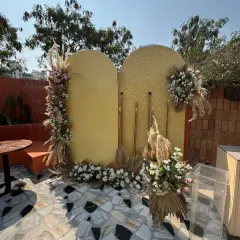 A daytime view of the 40th birthday setup, showing the gold shimmer wall and velvet backdrop before the party begins.