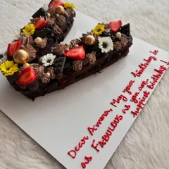 A "V" letter cake for a fabulous wife's birthday. This chocolate cake is loaded with frosting, fresh strawberries, and flowers.