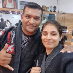 A photo with a respected senior practitioner after a tough but rewarding BJJ training session. The grappling community is built on mutual respect and a shared passion for learning.