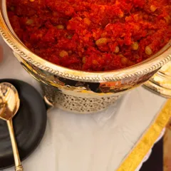 A close-up of our classic Gajar ka Halwa, a warm and comforting dessert made from grated carrots, milk, and sugar. It's a winter favorite, perfect for any festive buffet.